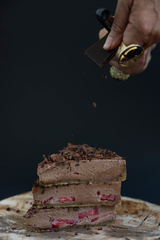 A stack of chocolate strawberry cheese cake