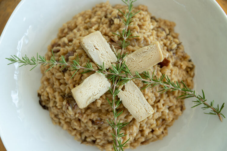 SriMu Porcini Risotto with cheese slices on top and plate seen from above