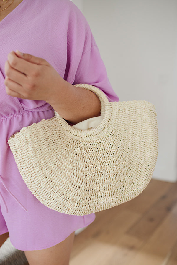 Close-up photo of a straw bag on a person's arm