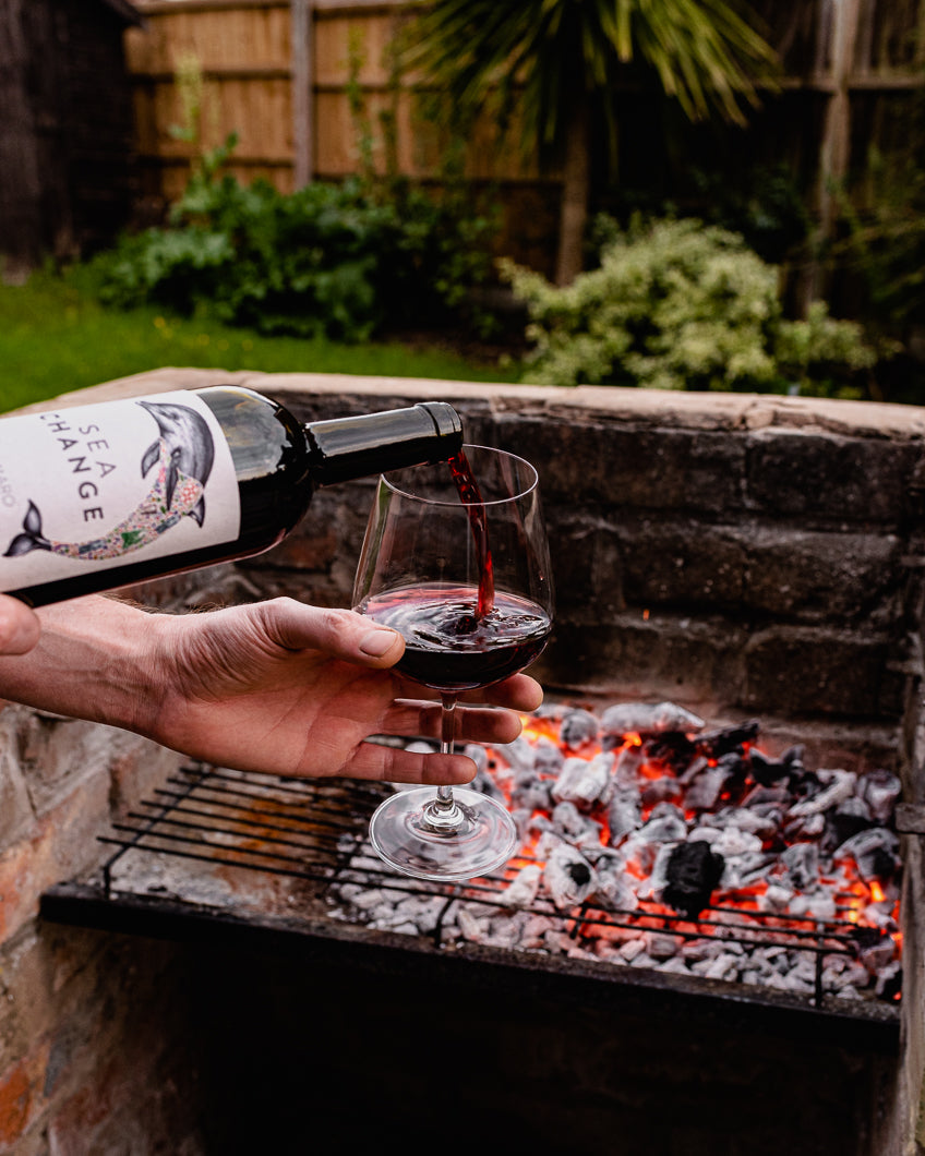 Negroamaro Wine poured in front of the barbecue