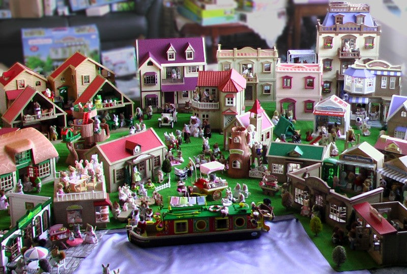 A Calico Critters city play area with a river and a boardwalk