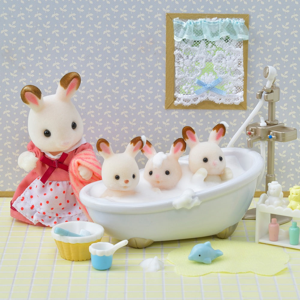 Chocolate Rabbit triplets are in the bathtub with their mother watching them