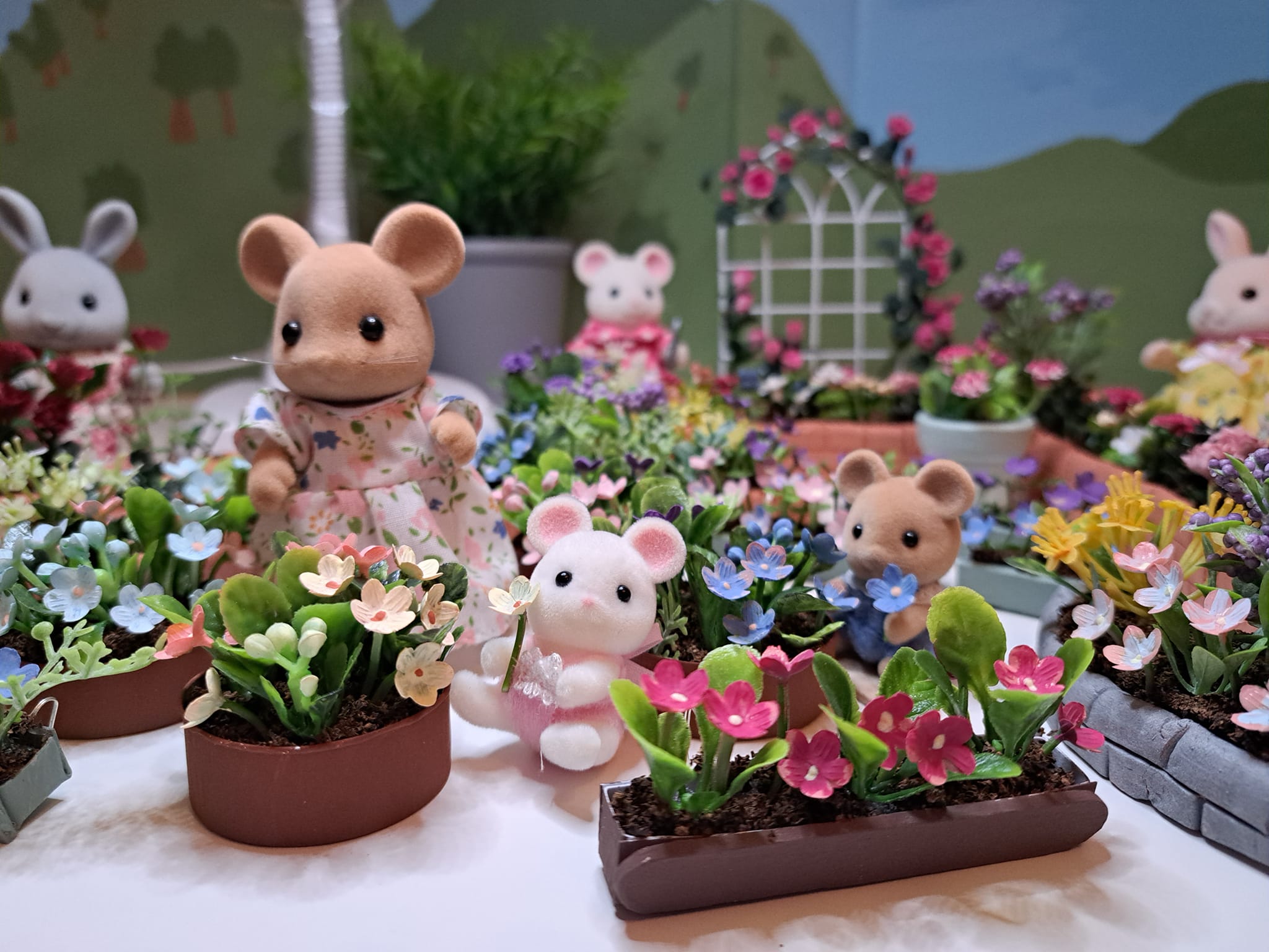 Lots of DIY flower beds and window boxes along with a few Calico Critters lounging around.