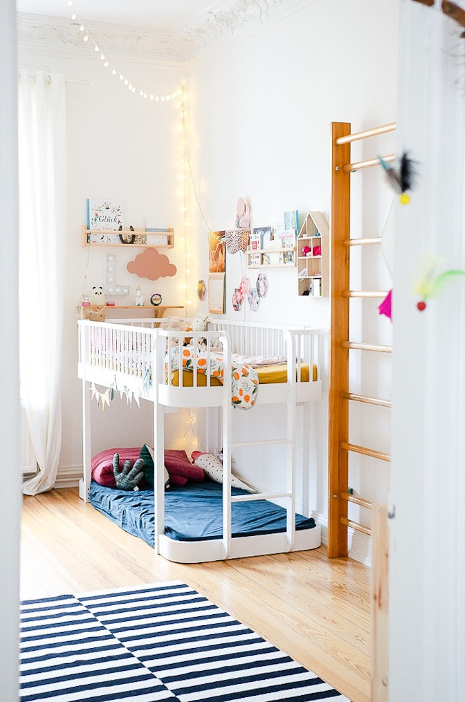 A jungle gym near a bunk bed.