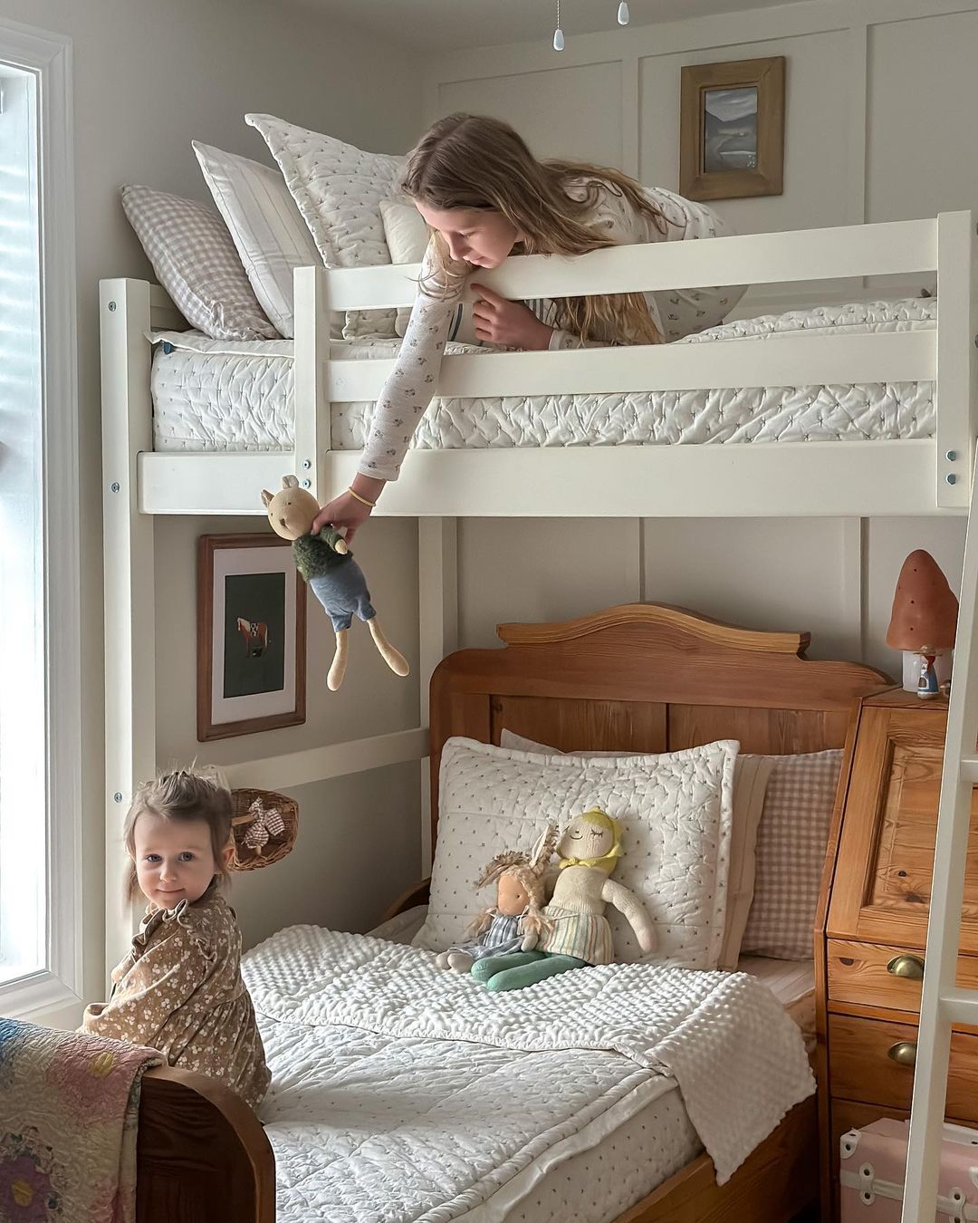 A sisters room with one loft bed and one regular bed beneath it.