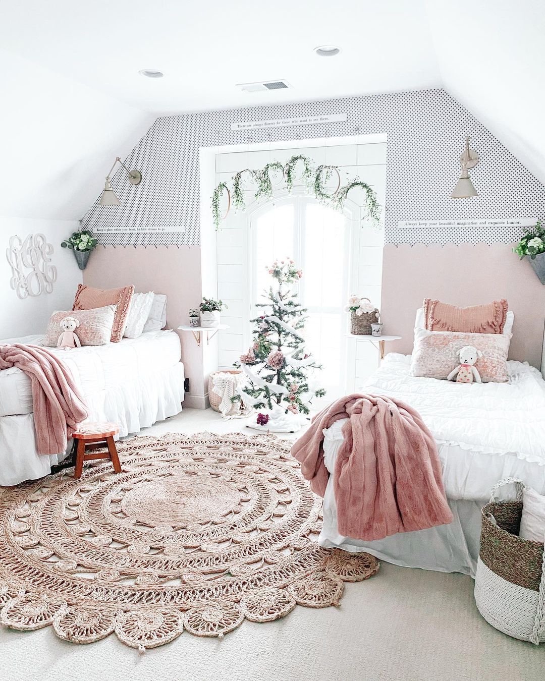 A sisters bedroom with a beautiful rug between the beds.