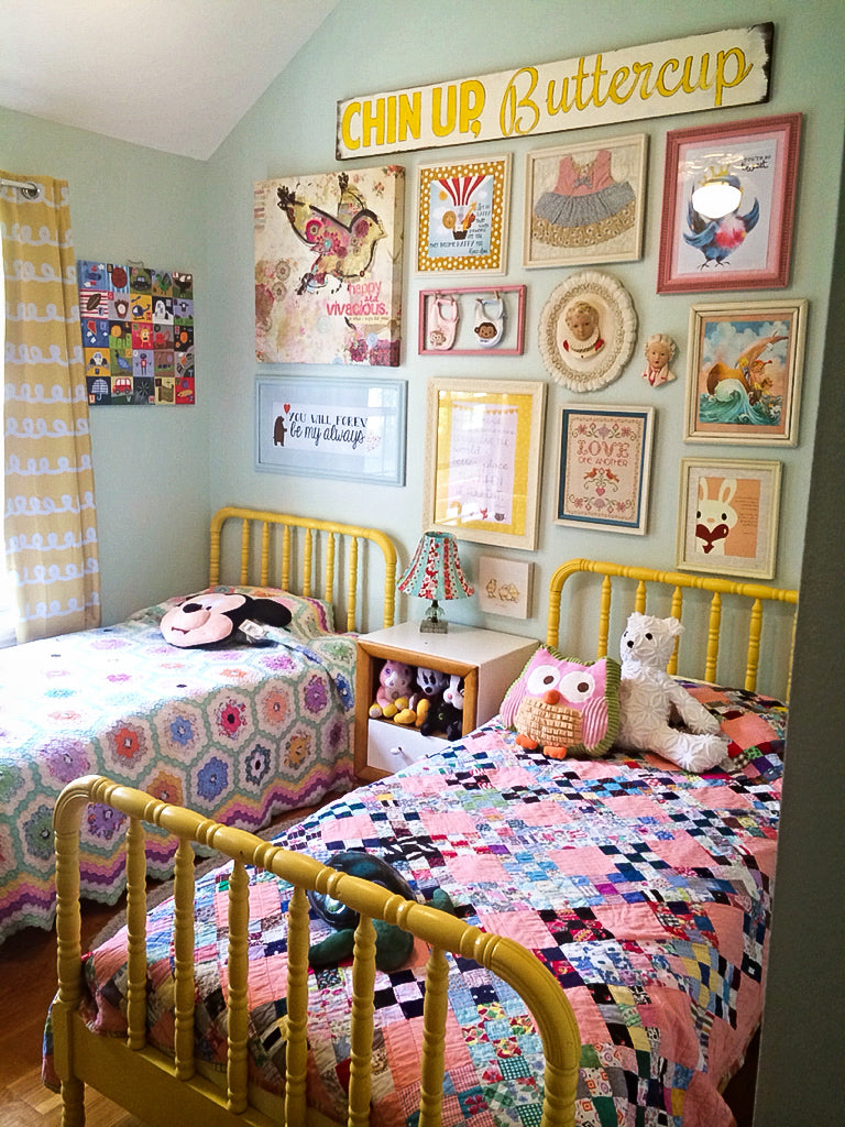 A colorful gallery wall in a sisters bedroom.