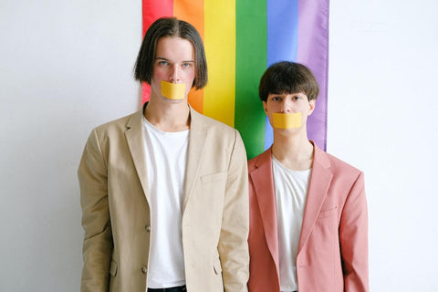 Two men with tape over the mouth