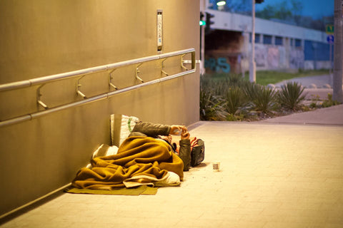 Person sleeping on the sidewalk