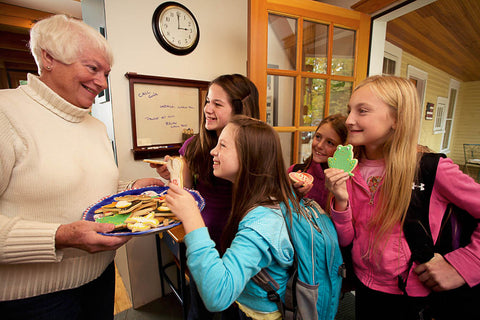 Ann Clark sharing cookies with young girls