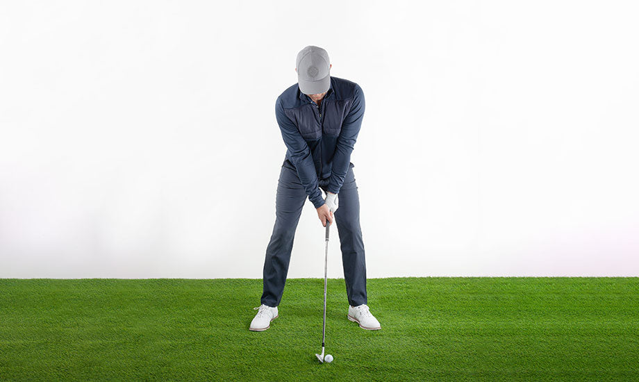 a golfer teeing up in the correct position