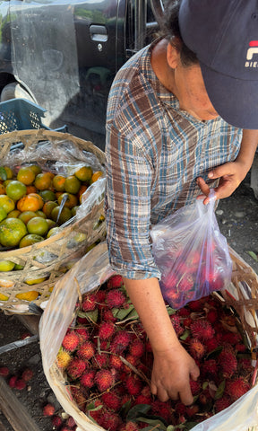 Indonesia market worker sorting fruit