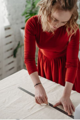 A girl measures a table