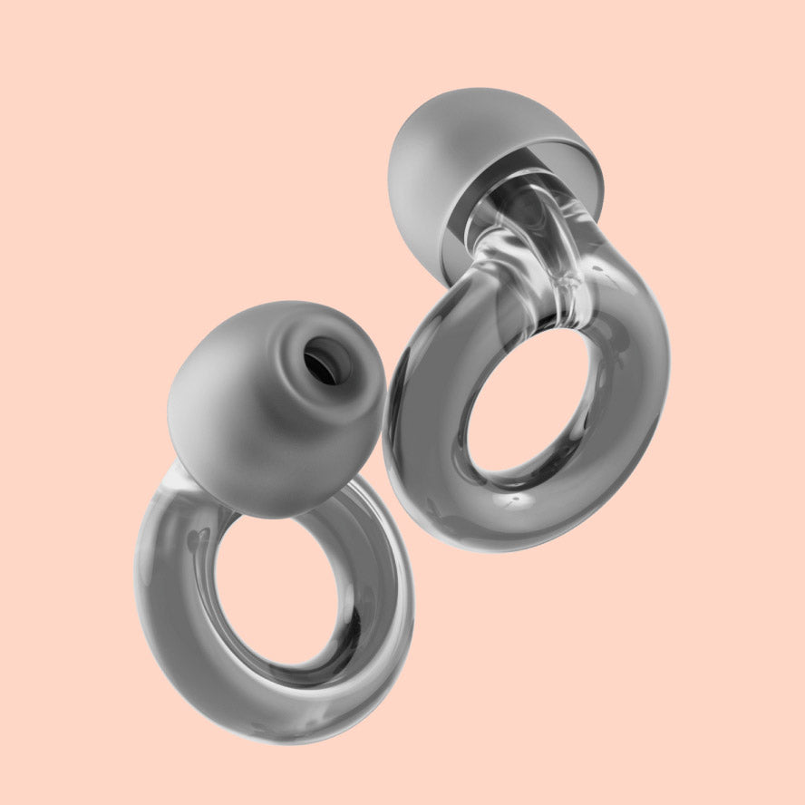 Silver loop earrings against a pale pink background.