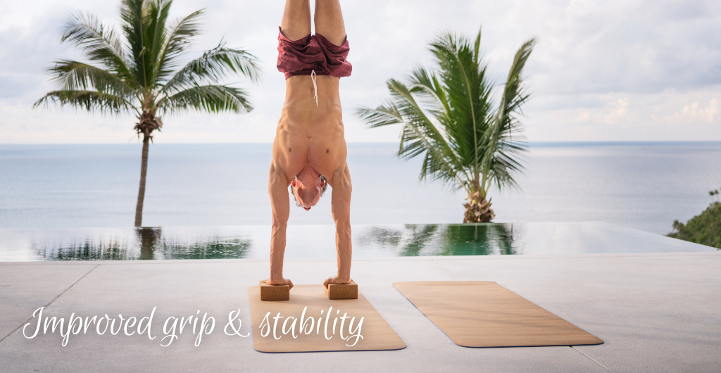 man doing handstand on cork yoga block and cork yoga mat