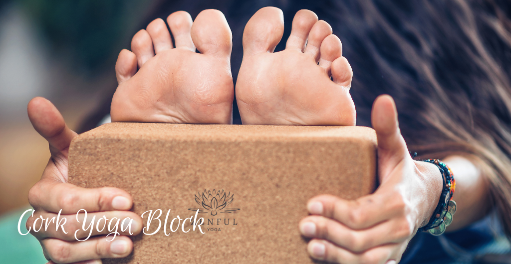 Should I buy a cork yoga block? Picture of a woman touching her toes using a cork yoga block