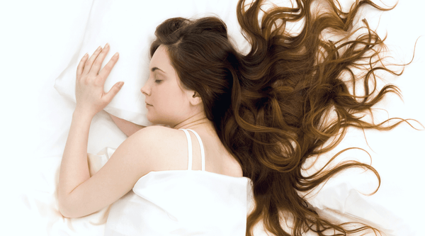 Woman with long hair sleeping on all-white sheets | Celestial Silk Mulberry Silk Pillowcases and Accessories