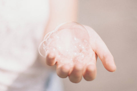 A hand with bubbles on the palm
