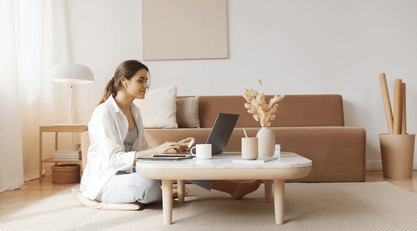 Woman sitting in the living room and researching on the laptop | Celestial Silk Mulberry Silk Pillowcase and Accessories