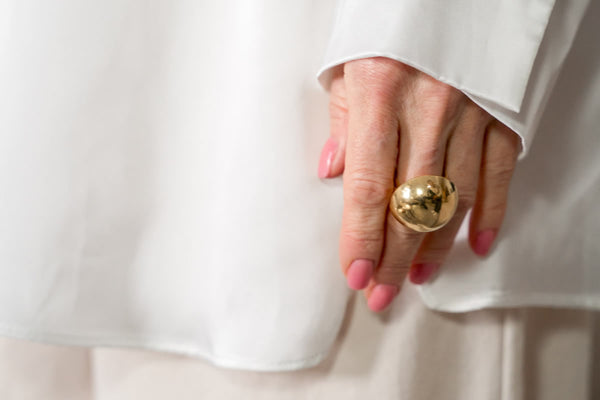 statement gold ring on old women hand
