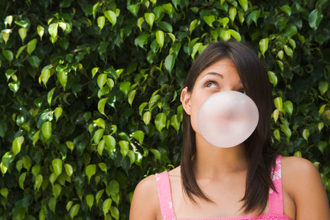 Women blowing a bubble 