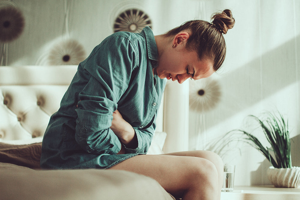 Woman with food poisoning waiting for mobile IV treatment.