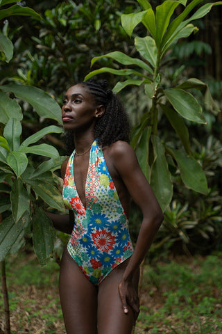 Model posing in nature in sustainable swimsuit