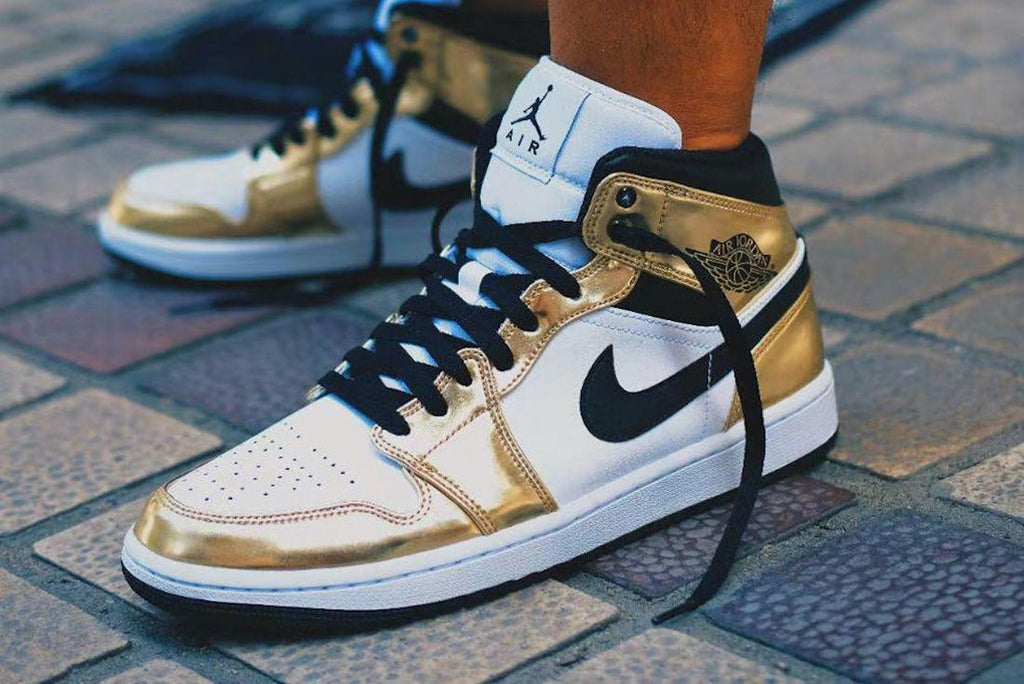 gold and black jordan 1 mid