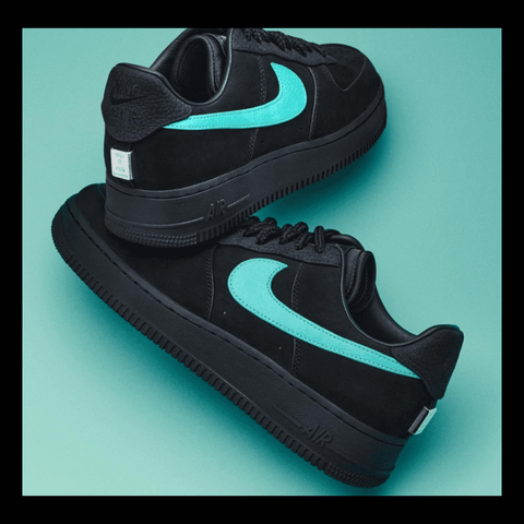 Close-up of the Nike Air Force 1 Tiffany Sneaker showing the clean black leather upper, metallic silver accents, and signature Tiffany blue color