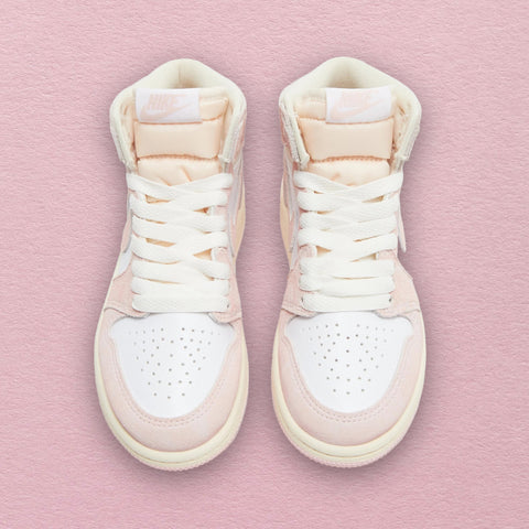 Nike Air Jordan 1 Retro High OG 'Washed Pink' Women Sneaker with soft pink leather upper, white accents on the Swoosh, laces, and midsole, and a Nike Air tongue tag.