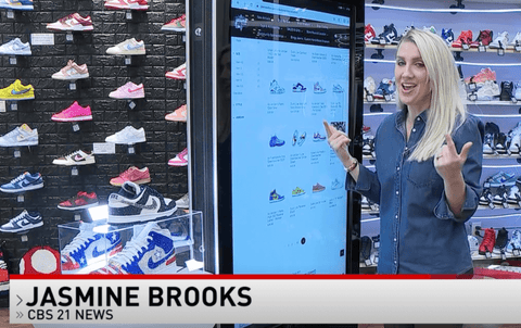 Jasmine Brooks using touchscreen to browse sneaker selection at Jawns on Fire Sneaker Boutique