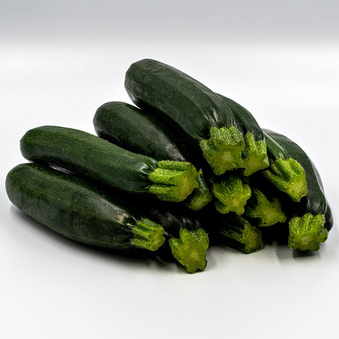 dark green courgettes piled on table