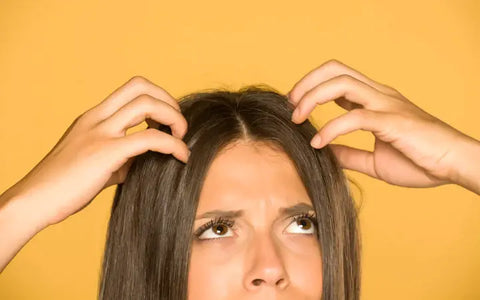 woman scratching her scalp