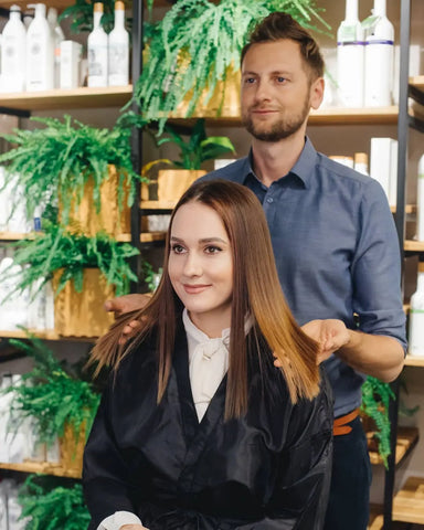 stylist showing their client their shiny hair