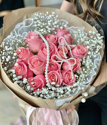 Pink rose bouquet with white pearls on top