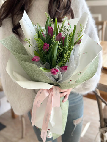 Girl holding pink tulips bouquet