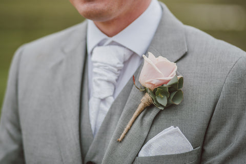 Man wearing boutonniere in grey suit