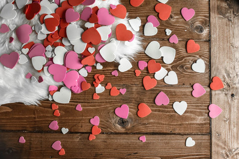 Colorful paper hearts on wood table