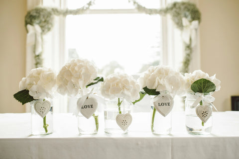 White peony bouquets on wedding table