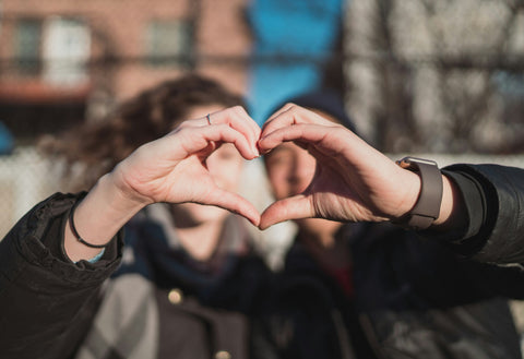 Couple making heart shape with hands