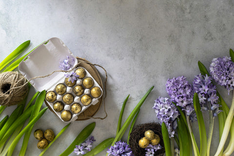 Gold easter eggs with purple flower bouquet