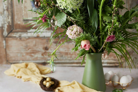 Geren and pink bouquet next to golden easter eggs