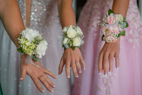 Corsage flowers on womens' wrists
