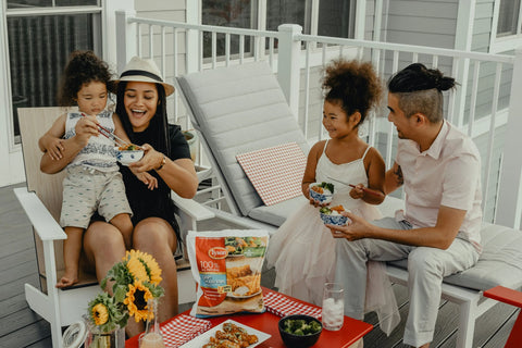 Husband, wife, and two kids dining outside