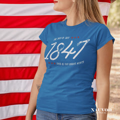 Woman wearing a blue Pioneer Day shirt with 1847