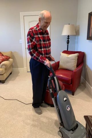 President Nelson vacuums at his home.