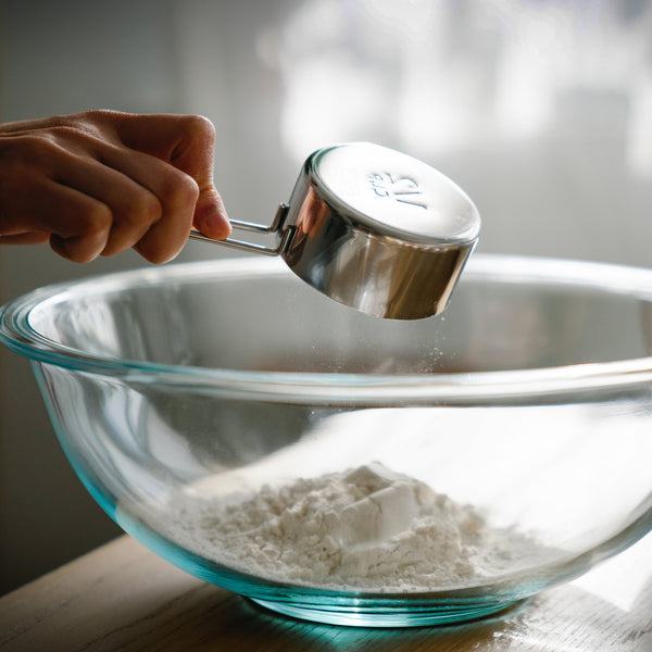 A measuring cup, not the best way to measure ingredient for pesto