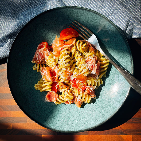 Pesto-pasta with cherry tomatoes and prosciutto