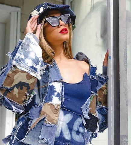 A model wearing one of Splashed by DKG's denim patchwork jackets and tops