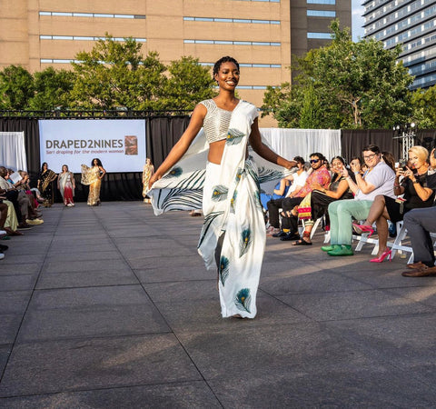 A woman models a stunning white saree.